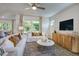 Comfortable living room with neutral decor and large windows at 166 Blue Butterfly Dr, Angier, NC 27501