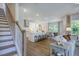 Elegant staircase with wooden banister and hardwood floors at 166 Blue Butterfly Dr, Angier, NC 27501