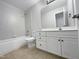 Clean bathroom with white vanity, tub, and tile floor at 4700 Linaria Ln, Fuquay Varina, NC 27526