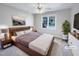 Virtually staged bedroom with a king-size bed, plush carpet, and large window at 4700 Linaria Ln, Fuquay Varina, NC 27526