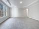 Spacious bedroom with large window, plush carpet, and access to bathroom at 4700 Linaria Ln, Fuquay Varina, NC 27526