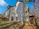White two story house with deck and sloping backyard at 4700 Linaria Ln, Fuquay Varina, NC 27526