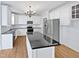 Spacious kitchen with white cabinets, granite island, and stainless steel appliances at 4700 Linaria Ln, Fuquay Varina, NC 27526