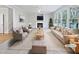 Virtually staged living room featuring a fireplace and ample natural light at 4700 Linaria Ln, Fuquay Varina, NC 27526