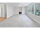 Spacious living room with a fireplace and large windows at 4700 Linaria Ln, Fuquay Varina, NC 27526