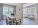 Bright dining room with a table for six, adjacent to a sunroom at 800 Heathered Farm Way, Apex, NC 27523