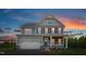 Two-story home with gray siding, white trim, and a charming front porch at 8833 Tartan Clan Dr, Angier, NC 27592