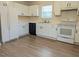 White kitchen with black appliances and vinyl flooring at 102 Shadow Bend Ln, Selma, NC 27576