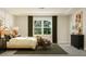 Bedroom with a king-size bed, two chairs, and large window at 1204 Coral Cay Bnd, Wake Forest, NC 27587