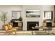 Living room with a fireplace, two armchairs, and a large TV at 1204 Coral Cay Bnd, Wake Forest, NC 27587