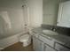Bathroom with granite countertop, grey vanity, and tub at 172 Tulipfield Way, Benson, NC 27504