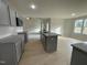 Open concept kitchen with gray cabinets and granite countertops at 172 Tulipfield Way, Benson, NC 27504