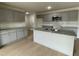 Modern kitchen with gray cabinets, granite counters, and island at 172 Tulipfield Way, Benson, NC 27504