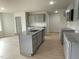 Modern kitchen with gray cabinets, granite counters, and island at 172 Tulipfield Way, Benson, NC 27504