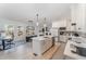 Open concept kitchen with island, white cabinets and stainless steel appliances at 210 Monteith Dr, Chapel Hill, NC 27516