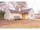 Beige house with a gray roof, small porch, and a partially fenced yard at 234 W Raleigh Blvd, Rocky Mount, NC 27803
