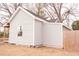 Light beige house with a gray roof, showing the side yard and a wooden fence at 234 W Raleigh Blvd, Rocky Mount, NC 27803