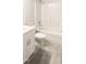 Clean bathroom with tub, toilet, and white vanity at 242 Liam St, Clayton, NC 27520