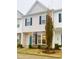 Two-story townhome with gray siding, teal door, and stone accents at 242 Liam St, Clayton, NC 27520