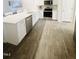 Modern kitchen with white cabinets and stainless steel appliances at 242 Liam St, Clayton, NC 27520