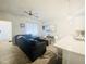 Living room with gray sectional sofa and view into kitchen and dining area at 242 Liam St, Clayton, NC 27520