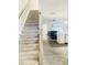 Carpeted staircase with light wood railing leading to the living area at 242 Liam St, Clayton, NC 27520