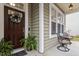 Inviting front porch with dark brown door and charming wreath at 3319 Silver Star Dr, Durham, NC 27713