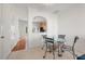 Dining area with glass-top table, four chairs, and kitchen access at 3539 Sugar Tree Pl, Durham, NC 27713