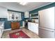 Modern kitchen with teal walls and white cabinets at 4913 Mitchell Mill Rd, Wake Forest, NC 27587