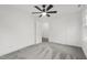 Spacious bedroom with grey carpet, ceiling fan and access to another room at 507 E Davis St, Smithfield, NC 27577