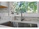 Modern kitchen sink with a sleek faucet and marble backsplash at 619 Lincoln St, Burlington, NC 27217