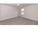 Simple bedroom with grey carpet and window at 68 Northwood Dr, Fuquay Varina, NC 27526