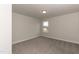 Simple bedroom with grey carpet and window at 68 Northwood Dr, Fuquay Varina, NC 27526