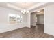Formal dining room with hardwood floors, chandelier, and wainscoting at 68 Northwood Dr, Fuquay Varina, NC 27526