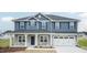 Two-story house with blue siding, stone accents, and a covered porch at 68 Northwood Dr, Fuquay Varina, NC 27526