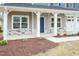 Covered front porch with stone accents and a blue front door at 68 Northwood Dr, Fuquay Varina, NC 27526