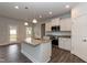 Modern kitchen with white cabinets, granite countertops, and an island at 68 Northwood Dr, Fuquay Varina, NC 27526