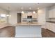 Modern kitchen with white cabinets, granite countertops, and an island at 68 Northwood Dr, Fuquay Varina, NC 27526