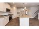 Open kitchen featuring granite island and hardwood floors at 68 Northwood Dr, Fuquay Varina, NC 27526