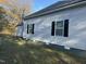 Side view of house, featuring gray vinyl siding and black window shutters at 708 E Highland Ave, Rocky Mount, NC 27801