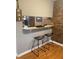 Kitchen features a breakfast bar, modern appliances, and brick accent wall at 807 W Trinity Ave # 209, Durham, NC 27701