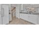 White kitchen cabinets, granite countertops, and stainless steel appliances at 9009 Grassington Way, Raleigh, NC 27615