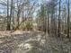 Image of a path through a wooded area with leaf-covered ground at 2001 Wheelers Church Rd Rd, Hurdle Mills, NC 27541