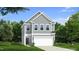 Two-story house with gray siding, white garage door, and landscaping at 1011 Shovelhead Dr # 6, Durham, NC 27703