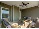Relaxing covered patio with ceiling fan, comfortable seating, and outdoor coffee table at 72 Macy Circle, Wendell, NC 27591