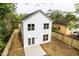 Aerial view of a white two-story house with a fenced backyard and small patio at 807 E Harnett St, Dunn, NC 28334
