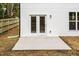Back patio of a white house with French doors and a wooden fence at 807 E Harnett St, Dunn, NC 28334