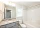 Clean bathroom with granite countertop, shower, and toilet at 807 E Harnett St, Dunn, NC 28334