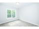 Spacious bedroom with plush carpet and a window at 807 E Harnett St, Dunn, NC 28334