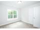 Bright bedroom with large window and carpeted floors at 807 E Harnett St, Dunn, NC 28334
